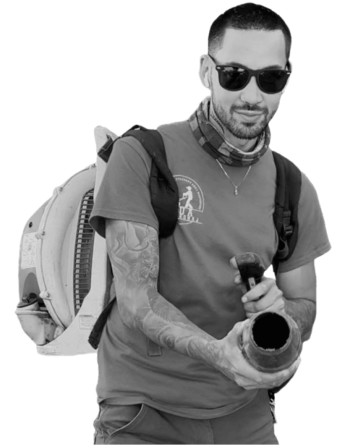 Owner of Aura Landscaping hold a lawn mowing leaf blower in Bellingham, WA